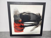 Framed Rubin Crispi abstract art print with black and red tones.