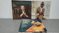 Front cover photo showing three vinyl LP albums included: Frank Sinatra's 'My Way', Tony Bennett's 'Greatest Hits', and Conway Twitty's 'Hello Darlin'. Covers show minimal wear.