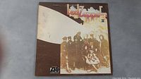 Front cover of Led Zeppelin II vinyl album showing band members and title artwork
