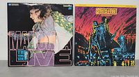 Two LaserDiscs side by side showing front covers: Madonna Live The Virgin Tour and Streets of Fire