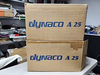 Two Dynaco A-25 branded cardboard boxes stacked