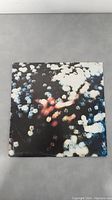 Front cover of Pink Floyd Obscured by Clouds vinyl album with abstract blurry bokeh light photo design.