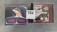 Top view of Bruce Cockburn double CD and The Cars CD 'Heartbeat City'