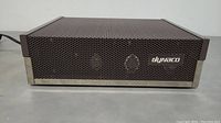 Front view of Dynaco amplifier showing perforated metal casing and Dynaco logo.