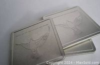 Silver metal tins embossed with a flying dove and Canada Post Millennium text