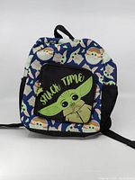 Front view of child size backpack with Grogu pattern and 'Snack Time' print pocket