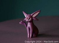 Front side view of the Espeon figure showing sitting pose, head, ears, and front paw details