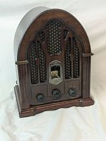 Front view of reproduction GE tabletop radio with cathedral style wooden cabinet, speaker grill, dial window, and control knobs.