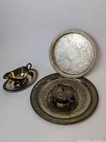 Photo showing all pieces including large platter, tray, gravy boat, and lidded garnish dish with trays and spoon