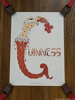 Full view of sophisticated Guinness poster showing the stylized figure with red-orange braided tail and 'GUINNESS' text.