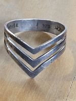 Photo showing inside band of the ring with .925, Mexico, and a third unclear stamp.