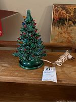 Full view of assembled green ceramic tree with multicolor plastic bulbs and attached power cord