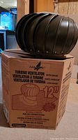 Airhawk 12-inch turbine ventilator mounted on original box in basement setting.