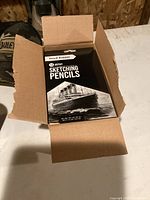 Open box showing one pack of artist sketching pencils with vintage ship image on front.