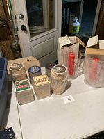 Photo showing all coaster sets and Budweiser pitchers on table with door background