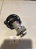 Full view of the Porter-Cable cut out tool showing body, cord, and cutting bit.