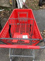 Photo of shopping cart taken from the top showing the basket and child seat area with securing strap.