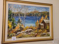 Framed oil painting showing an autumn landscape with birch trees, lake, rocks, and wooden cabins, signed by DJ Durst.
