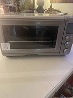 Front view of toaster oven showing exterior, glass door and control panel