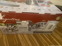 Exterior of Lagostina Ambiente cookware set box showing brand and '15 piece set' marking, shipping labels applied