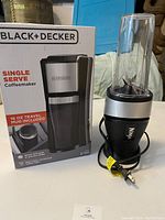 Photo showing Ninja blender alongside Black+Decker single serve coffeemaker and its box