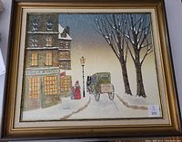 Full view of the framed winter street scene painting showing building, figures, horse carriage, snow, and lamp post.