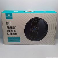 Closed retail box of D40 Deenkee Robotic Vacuum Cleaner showing product image and key features.
