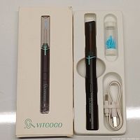 Box and contents of the Vitcoco Y13 earwax removal tool, including the black main device, silicone tips, USB cable and protective cap.