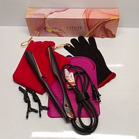 Full view of hair styling tool, glove, mat, clips, and box.