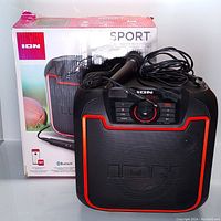 ION Sport rechargeable Bluetooth speaker with wired microphone and power cable, shown with original packaging.