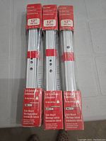 Photo showing 3 unopened packs with 2 drawer slides each, labeled 12 inch side mount, 3/4 extension, 75 lbs capacity.