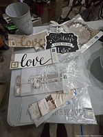 Top-down view of stencils, signs, and metal bucket showing the lot contents