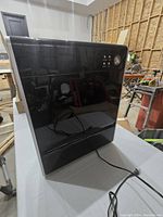 Black rectangular Asept-Air air cleaner with control panel and power cord, seen from front and side angles.