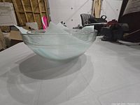 Side view of largest clear glass bowl showing round shape and smooth rim