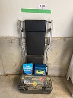 Front view of the auto maintenance creeper with the battery, magnetic parts tray, and battery box placed in front.