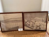 Two framed sepia photographic prints of Lion’s Gate Bridge displayed side by side