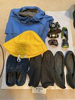 Full lot overview including blue jacket, yellow hat, four headlamps, green flashlight, and three pairs of shoes.