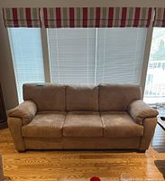 Front view of beige microfiber sofa showing three seat cushions and plush back