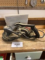 Sears Craftsman Detail Sander and Planer placed on wooden surface with dust protective sheet behind