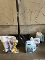 Image showing the Vulcan snow shovel blade, Safe Step ice melt salt bag, and three containers of liquid including windshield cleaner.