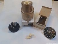 Cuisinart food processor base unit with attachments arranged around it on a white surface