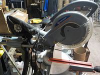 King Canada 10" sliding compound miter saw mounted on Mastercraft folding roller stand in workshop