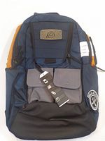 Front view of backpack showing Konoha Leaf metal patch, front pockets, and orange side panels.