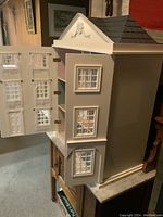 Angled view of exterior showing side elevation and partially open front doors