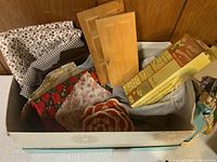 Box filled with assorted fabric, cardboard miniature door, and a boxed item labeled 'Magic Masonry'.