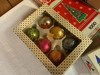 Set of 6 assorted colorful vintage glass Christmas ball ornaments in original box with a white star-patterned border