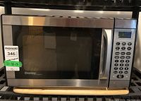Front view of Danby Designer microwave showing stainless steel finish and control panel.