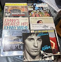 Photo showing vinyl LPs including Johnny's Greatest Hits by Johnny Mathis, The River by Bruce Springsteen, and more.