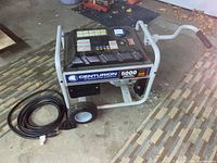 Front perspective showing entire generator, frame, wheels, handle and power cable