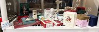Photo of all assorted holiday ornaments and boxes including Hallmark, Lenox, Reed & Barton, and other collectible ornaments.
